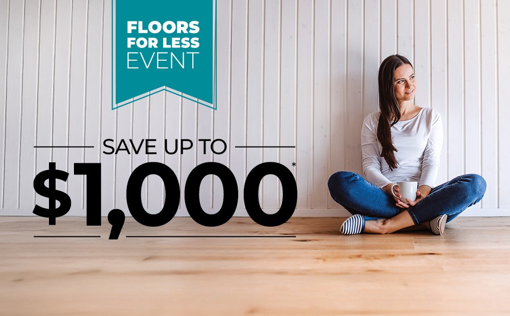 Woman sitting on hardwood floor drinking coffee